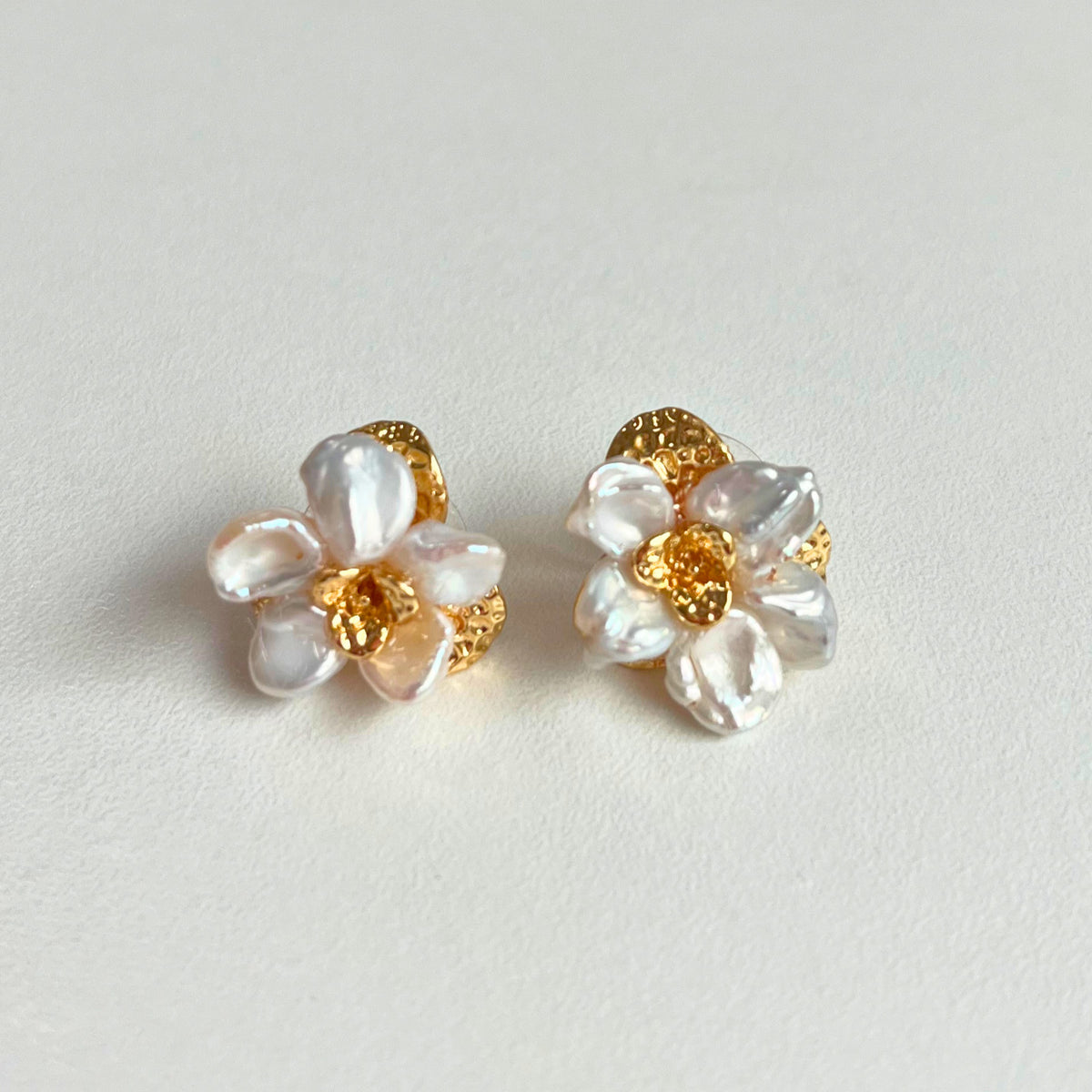 Baroque Pearl Flower Stud Earrings — baroque pearl petals clustered into a flower around a hammered gold centre