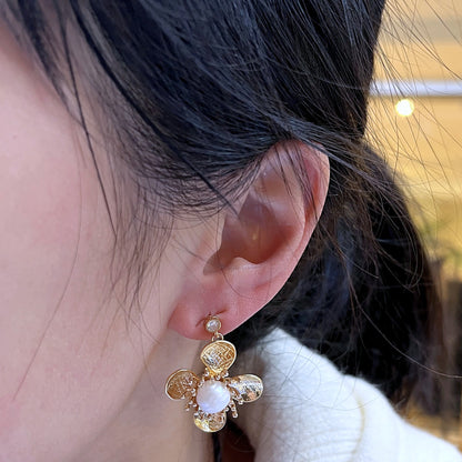 Trèfle Pearl Studs — hand-textured gold petal bloom with freshwater pearl centre