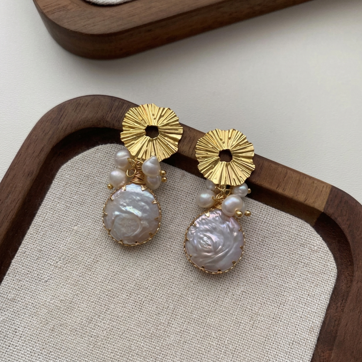 Soleil Baroque Pearl Drops — gold sunburst disc with pearl cluster and baroque coin pearl drop